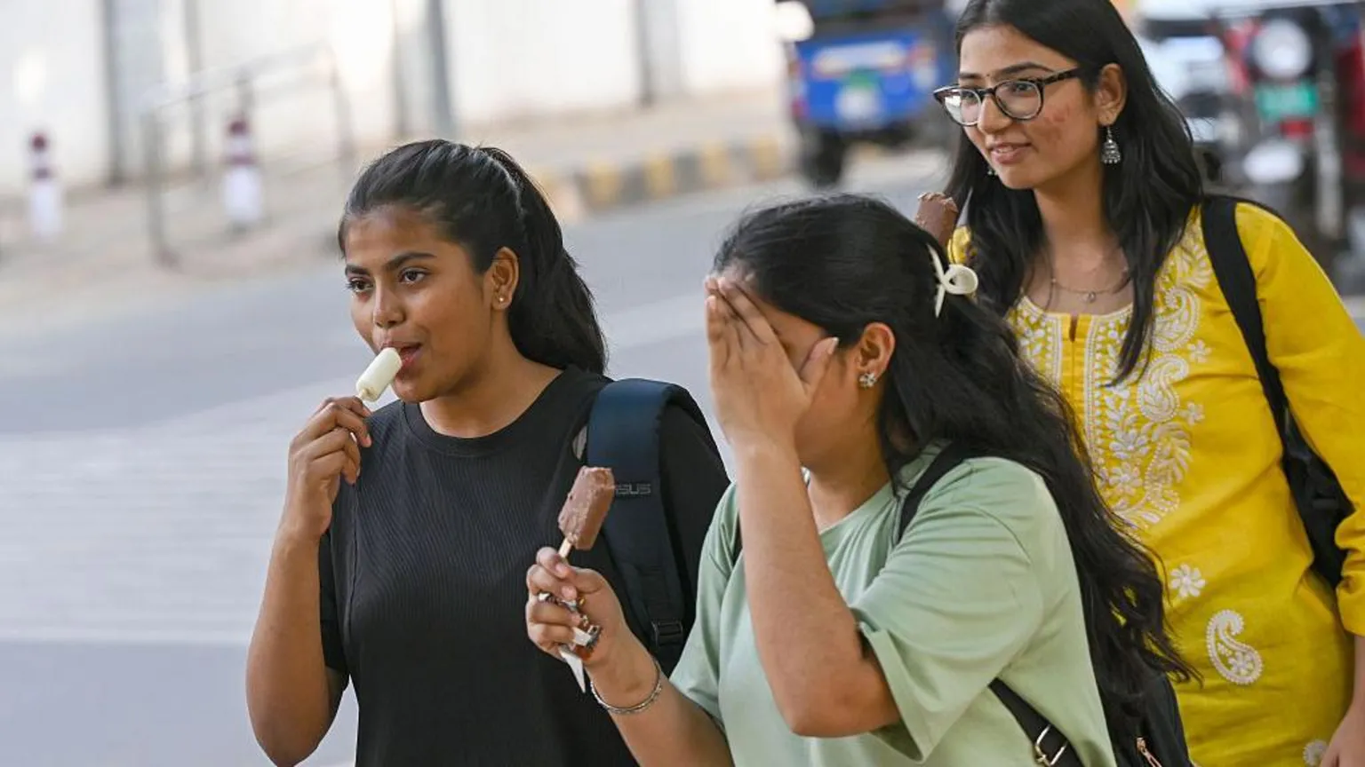  People step out on a hot afternoon near north campus Delhi University, on April 19, 2026 in New Delhi, India.