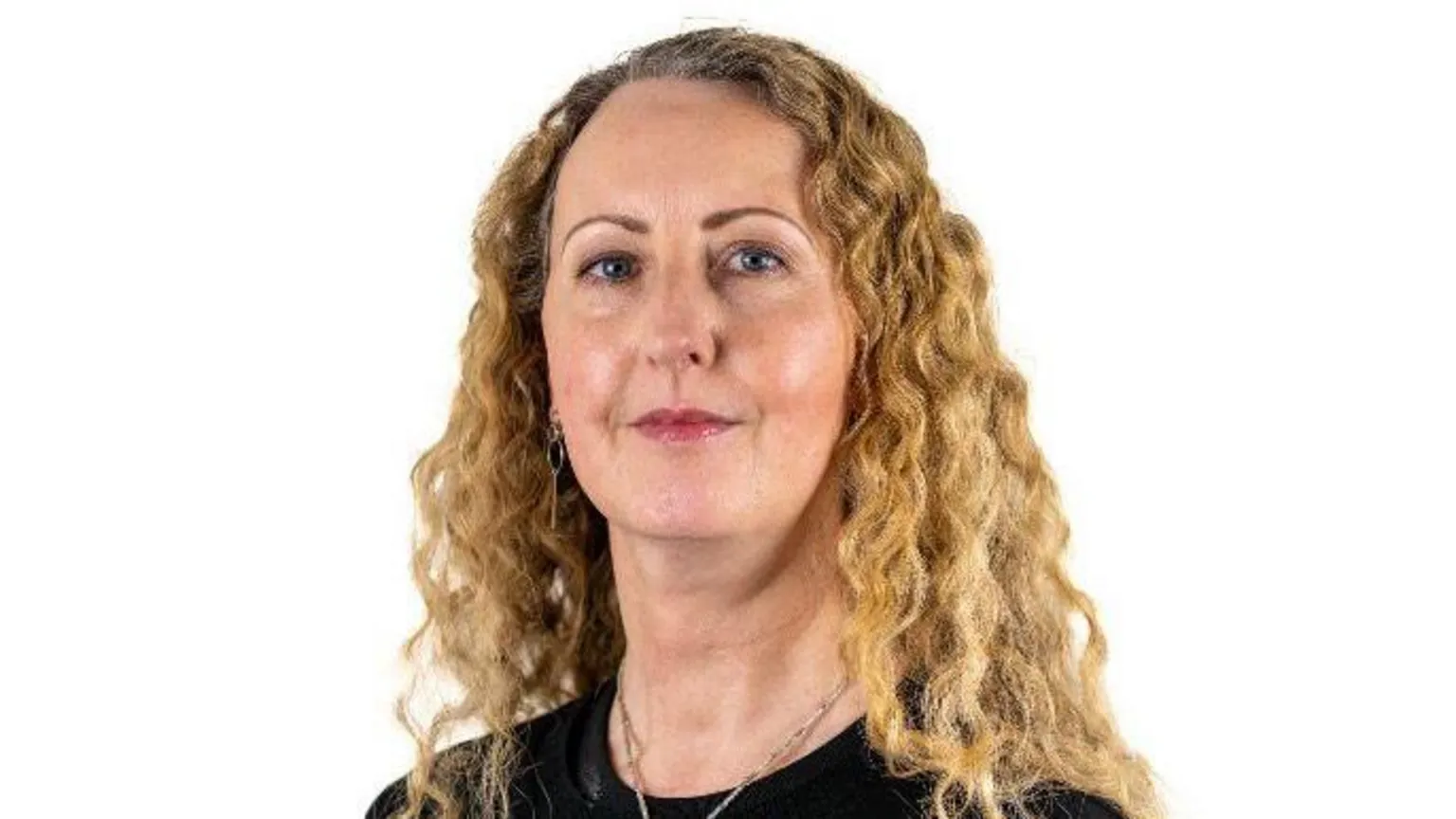 Children's Law Centre A woman, with long blonde curly hair, wearing a black top. 