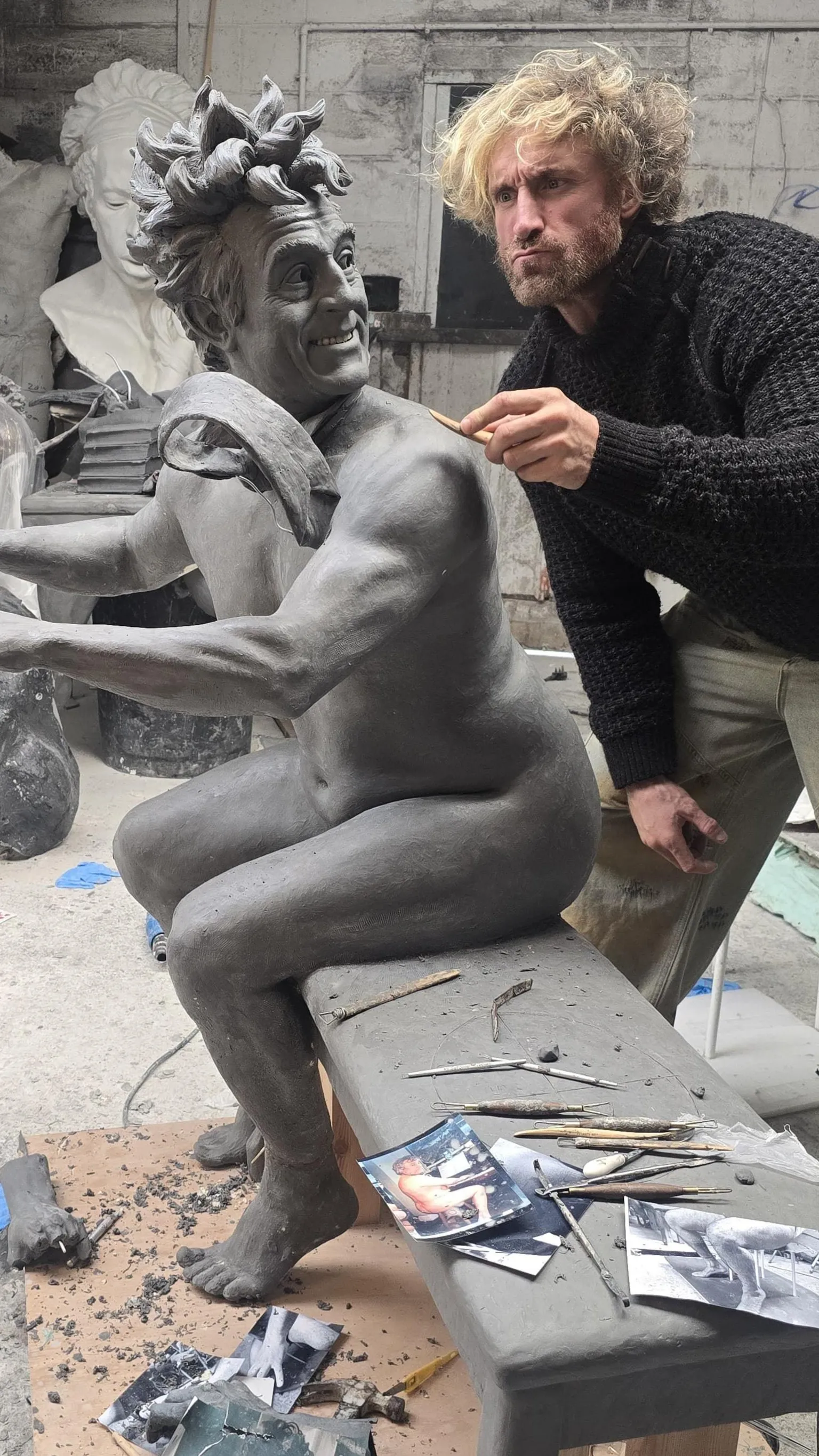 Nick Elphick Nick Elphick scraping some clay from the sculpture of Terry Jones in his workshop
