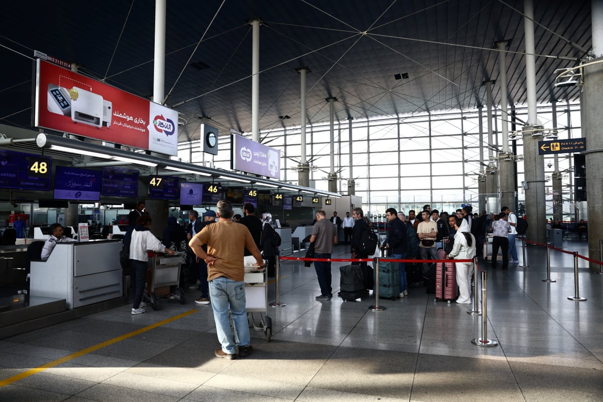 Passengers stand in a line at the terminal hall in Imam Khomeini International Airport, in Tehran, Iran.