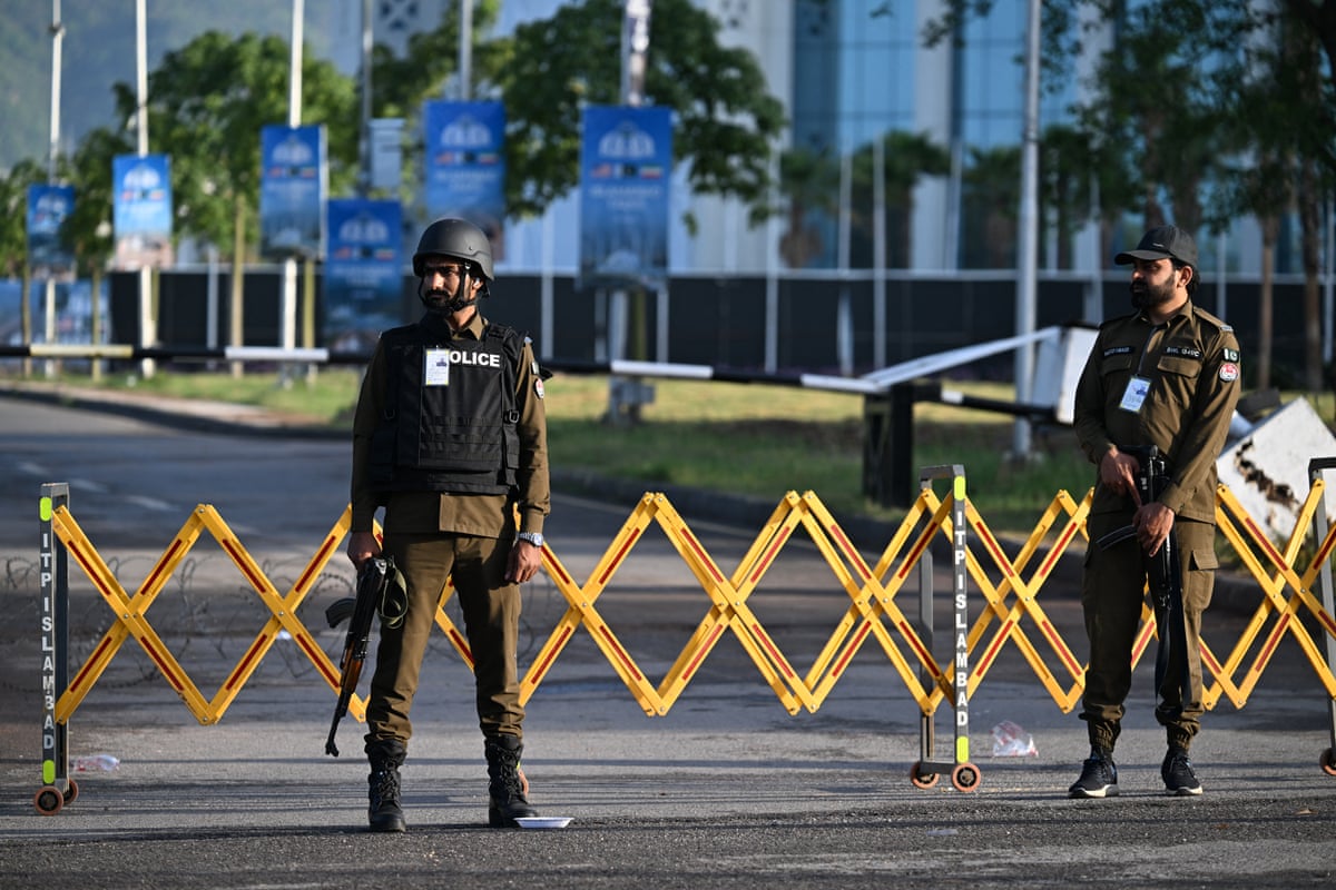 Police officers stand guard near the Serena Hotel