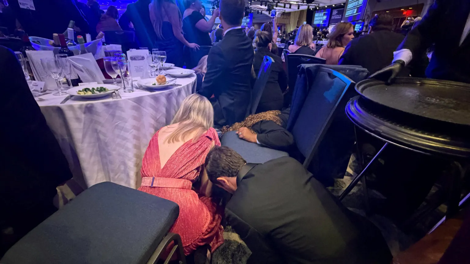  Guests take cover after US President Donald Trump and first lady Melania Trump were rushed out of the White House Correspondents' Association dinner.