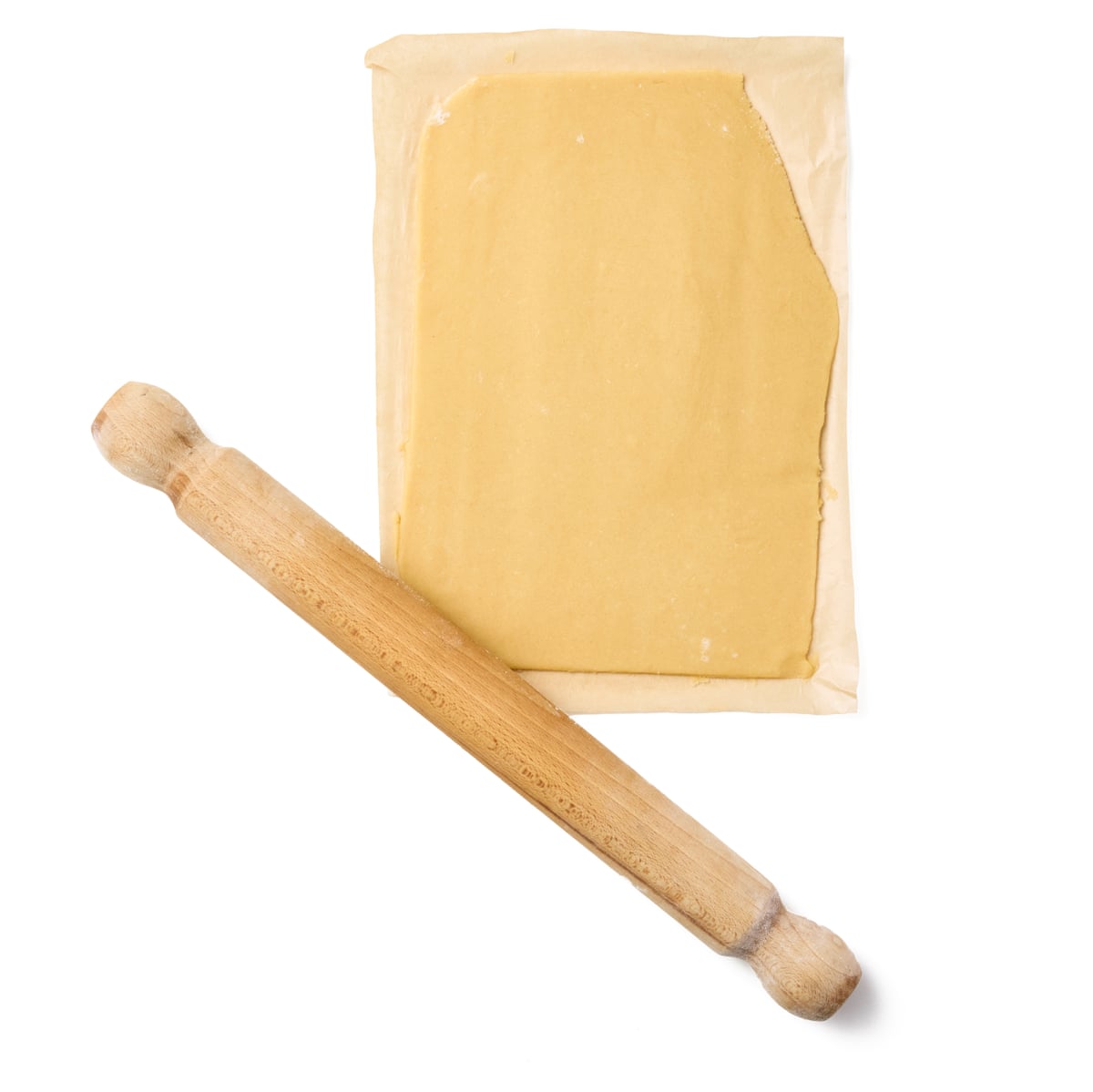 Felicity Cloake’s custard creams. We have cut out a sheet of baking paper large enough to line a baking tray, then put this on a work surface and lightly sprinkled with flour. Roll out the dough to about 3mm thick.