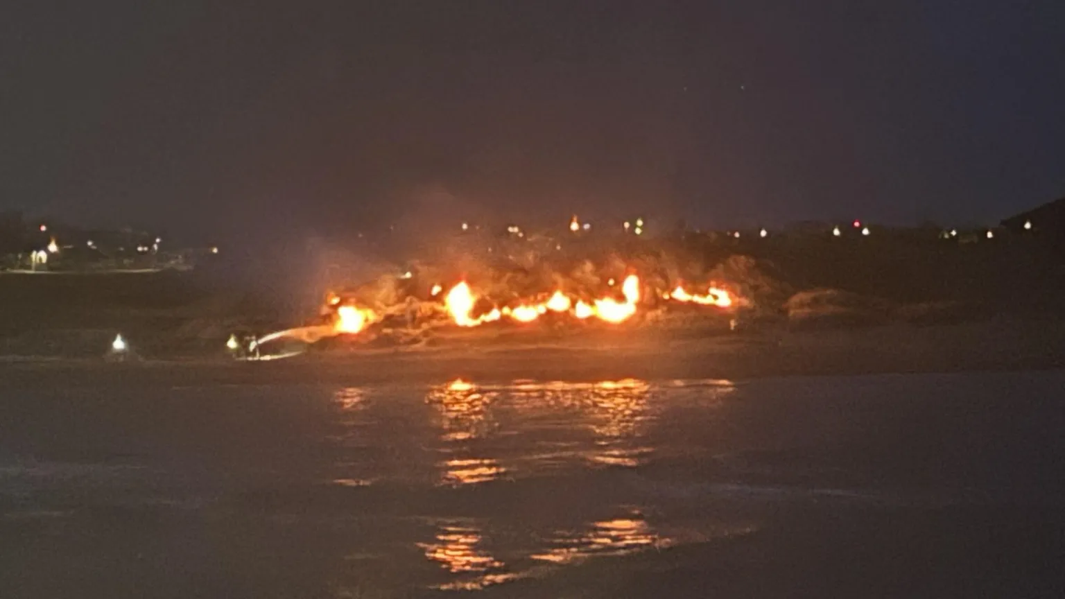A large fire spread across a beach during the night
