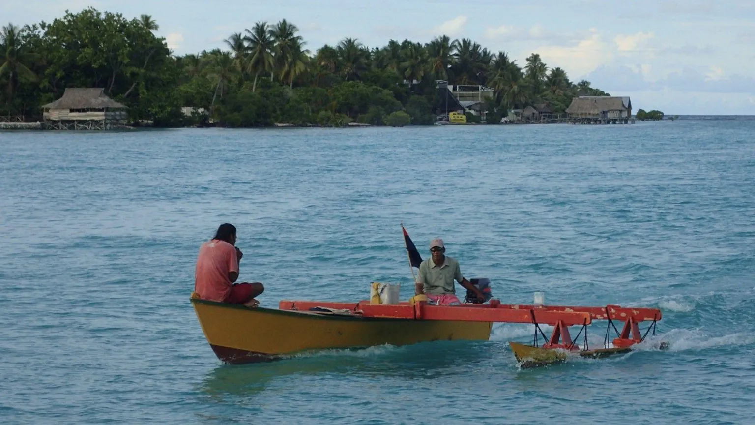 Simon Diffey Two fishermen sat on a boat off the coast of Kiribati