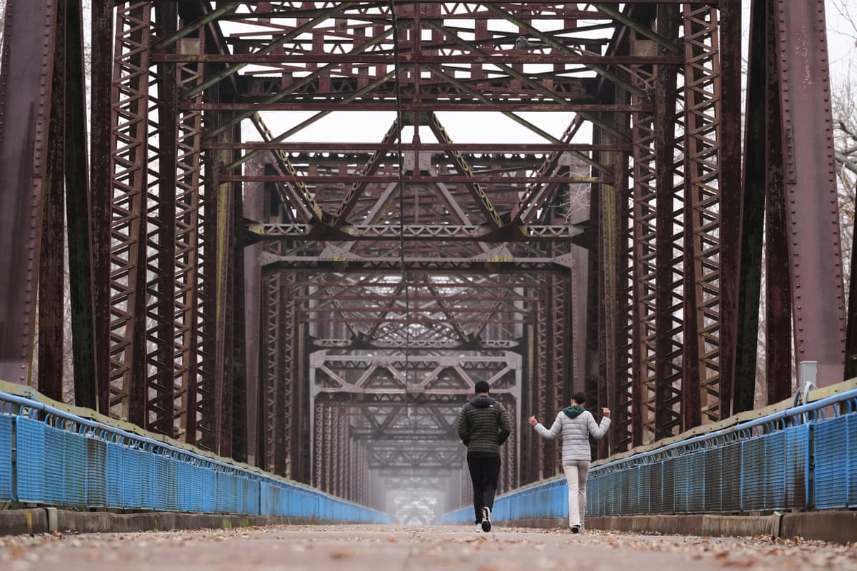 People walk along the traffic-free Chain of Rocks Bridge