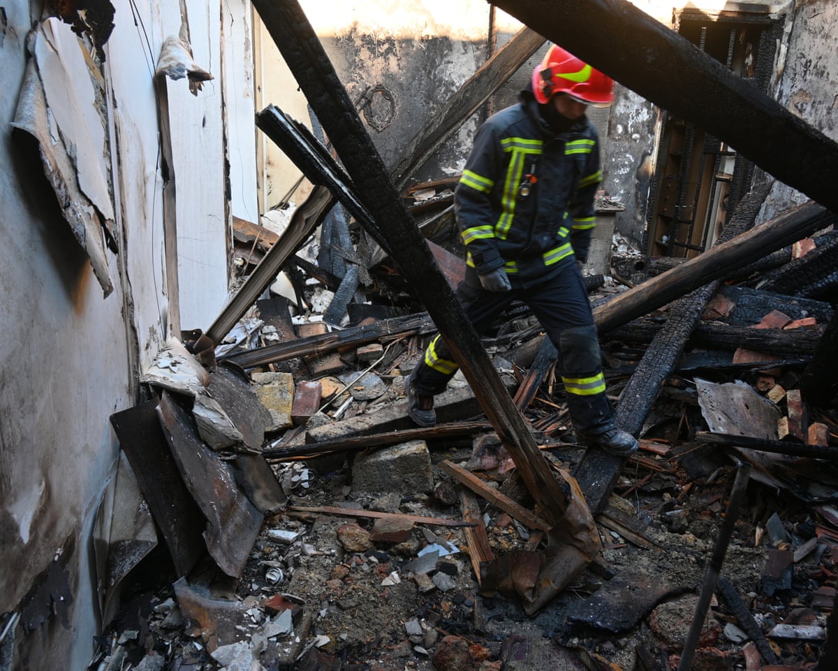 A rescue worker walks inside apartments destroyed by a Russian strike in Odesa, Ukraine.