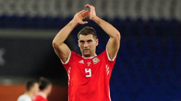 Wales striker Sam Vokes applauds