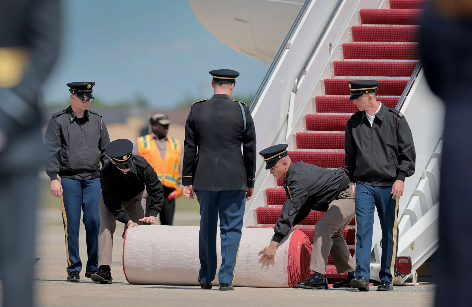  Members of the U.S. military roll out a red carpet at the foot of the stairs to the plane carrying King Charles III and Queen Camila on day one of their State Visit to the United States, on April 27, 2026 at Joint Base Andrews, Maryland.