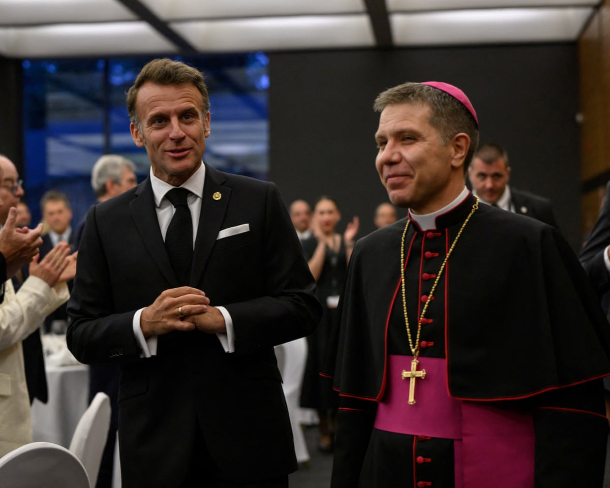 France's president and Andorra’s co-prince Emmanuel Macron arrives as he is welcomed by the second co-prince Josep-Lluis Serrano Pentinat (R), ahead of a dinner in Andorra.