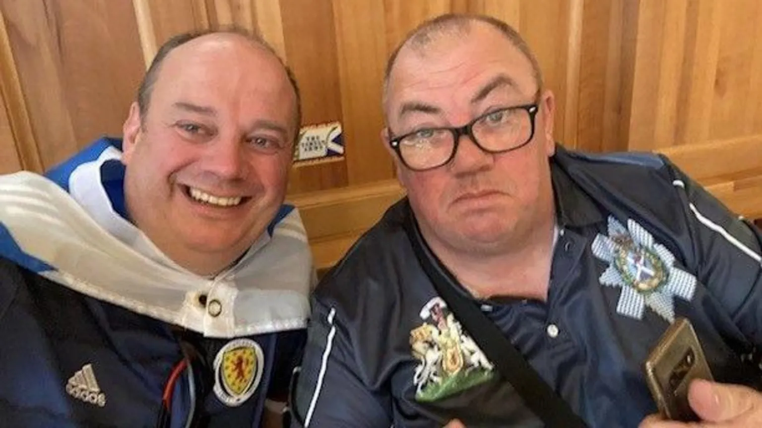 Davy Hood Two men taking a selfie, both wearing Scotland tops