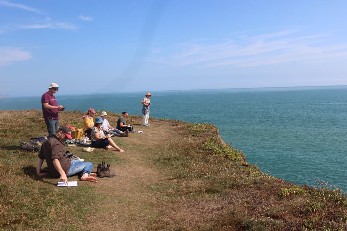 People sitting on a cliff top