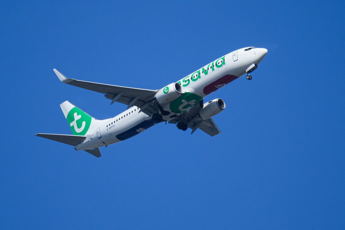 A low-cost Air France subsidiary Transavia plane flies over Nantes, western France.