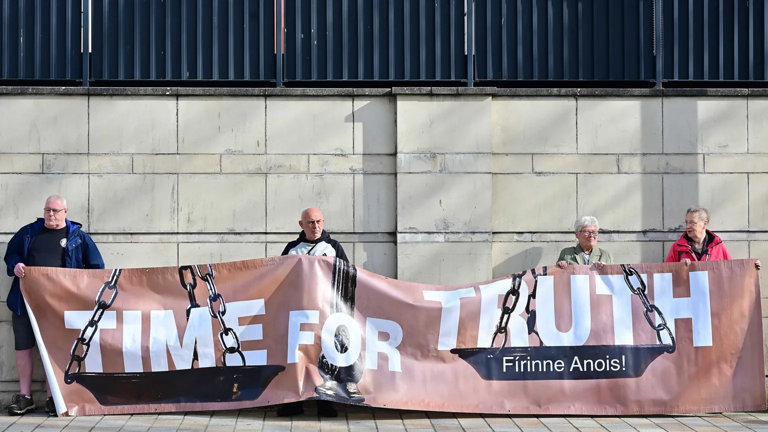 PACEMAKER Four people holding a brown banner with 'Time for Truth' written on it in white writing.