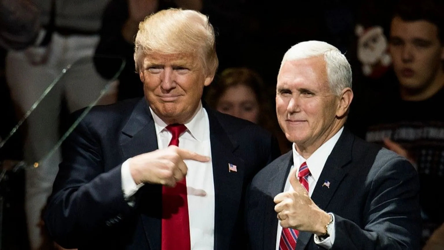  President Donald Trump points at Vice President Mike Pence at stage in 2016.
