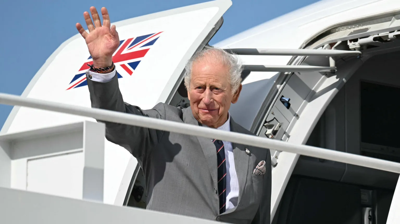  Britain's King Charles III waves as he boards his plane at Joint Base Andrews in Maryland.