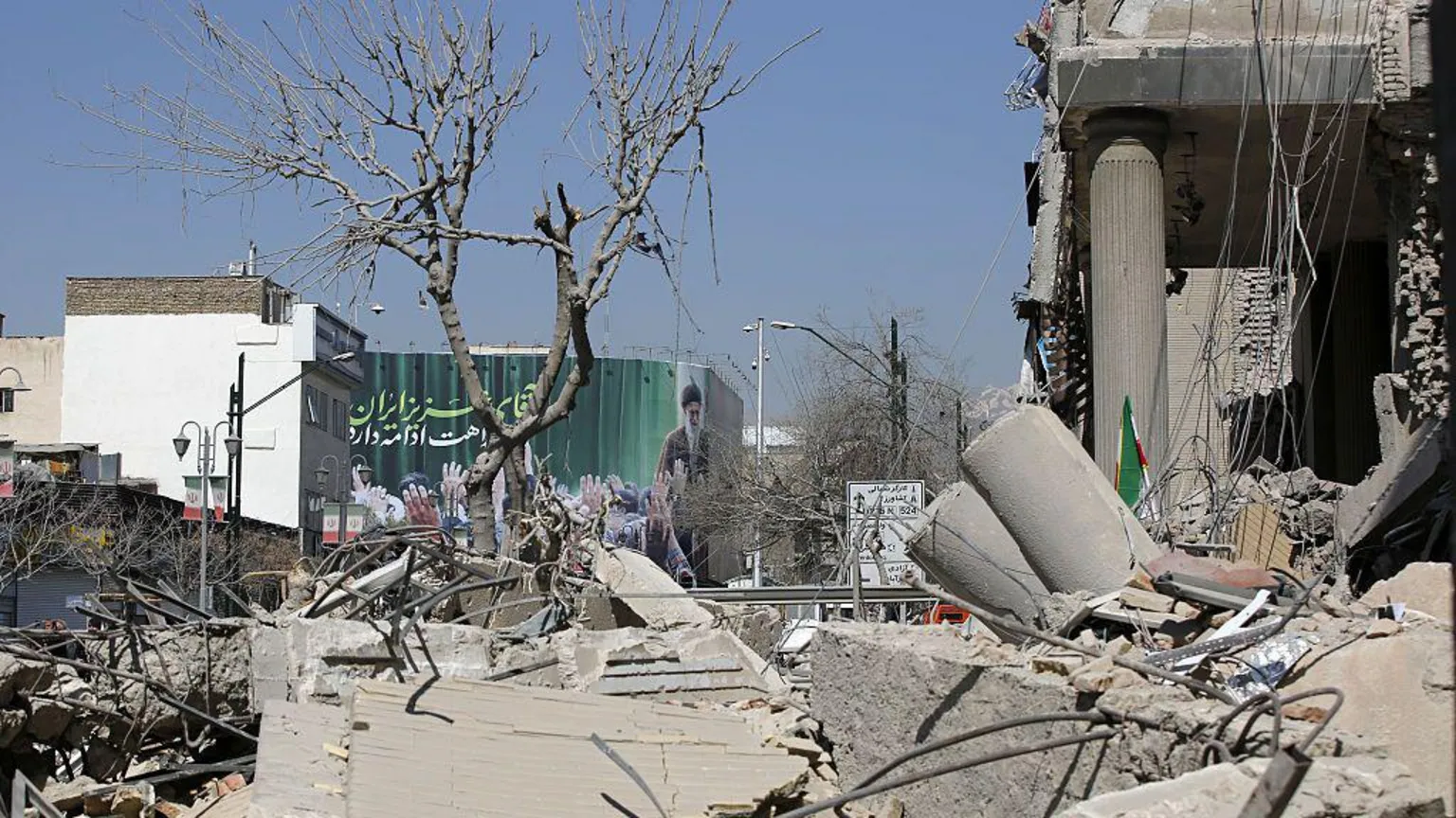 Fatemeh Bahrami/Anadolu via A view of destruction on Enqelab Square following the attacks launched by the US and Israel on Tehran. Rubble and large slabs of concrete cover the ground. 