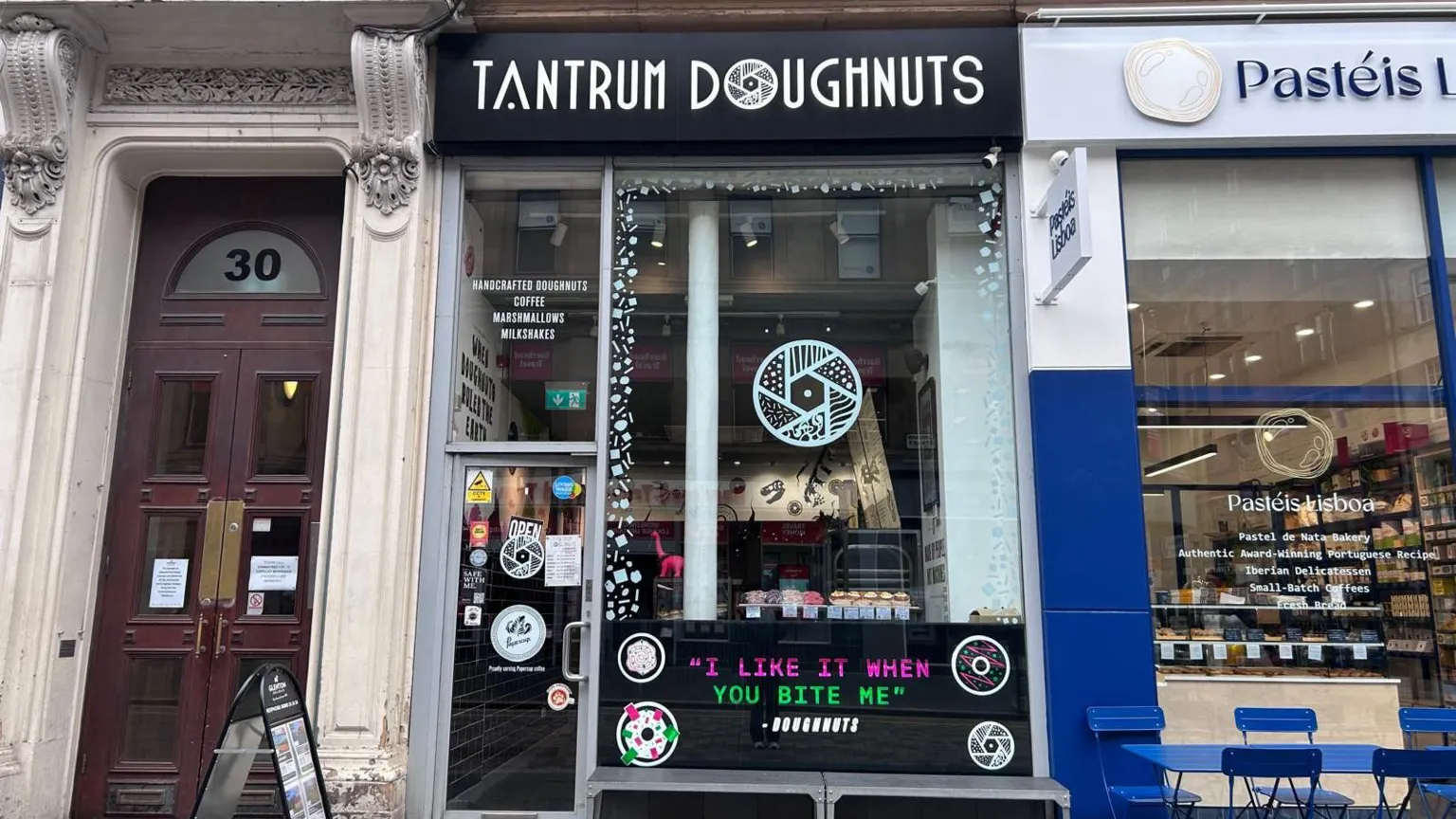 Tantrum Doughnut's shop front. The signage is black and white with drawings of doughnuts.
