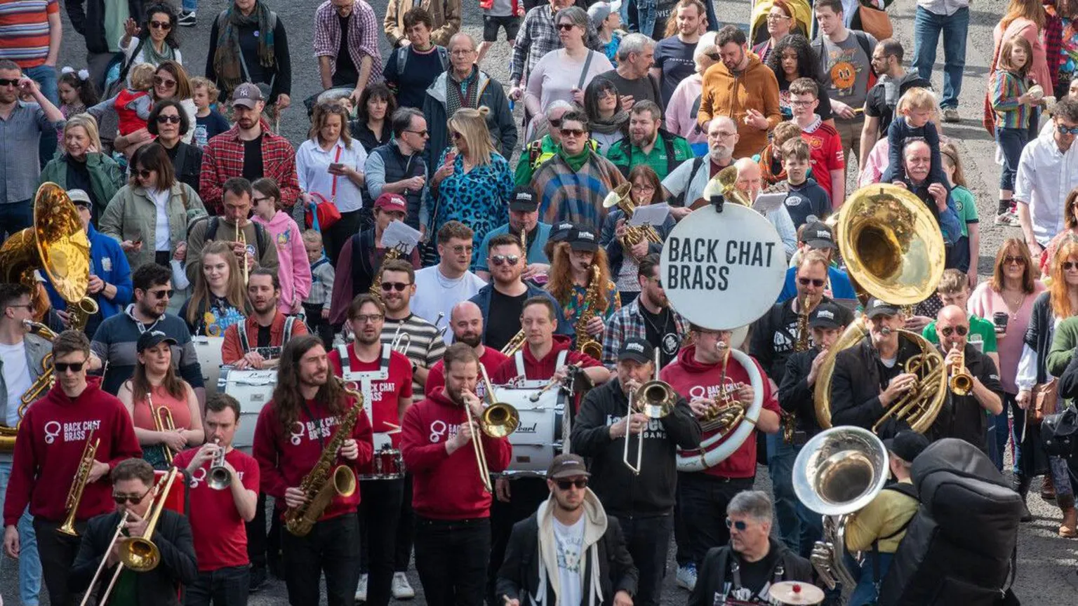 Derry City and Strabane District Council on the street performers at city of derry jazz festival are surrounded by a crowd of people