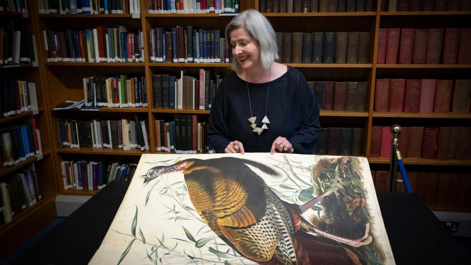 Kirsty Anderson/Royal College of Physicians and Surgeons of Glasgow Claire McDade turning the page of the book