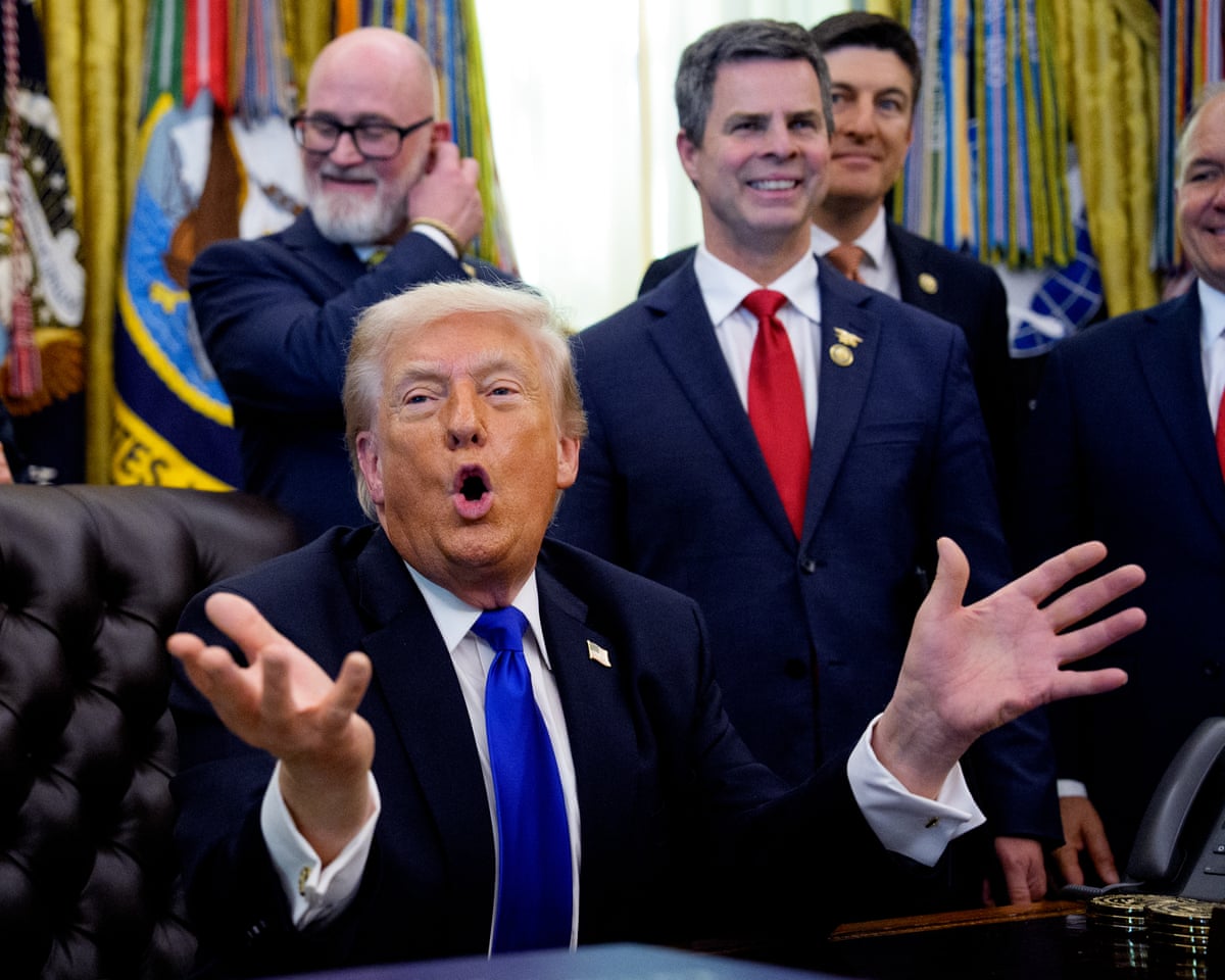 US President Donald Trump, accompanied by Republican members of Congress, speaks to reporters after signing executive orders in the Oval Office of the White House on 30 April.
