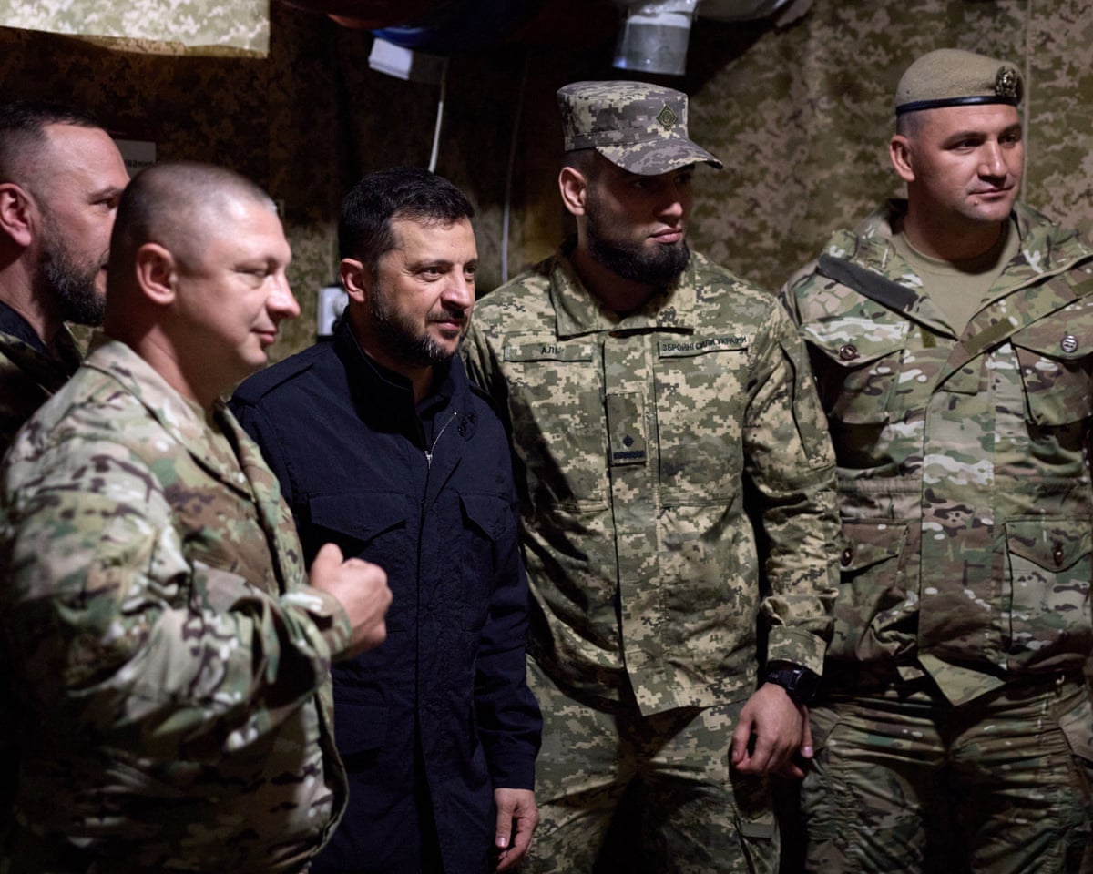 Ukraine's President Volodymyr Zelenskyy poses for a photo with Ukrainian soldiers on the frontline positions at an undisclosed location in the Donetsk region, amid the Russian invasion of Ukraine.