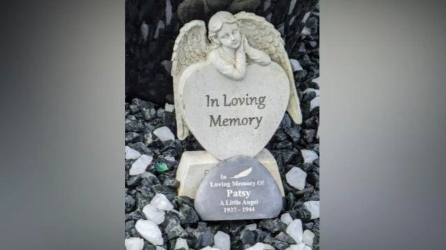 Annie Kalotschke A stature with an angel praying above a heart with a stone with the words Patsy. A little angel