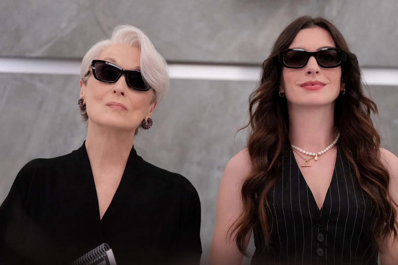 Walt Disney Studios Picture of Meryl Streep and Anne Hathaway both in black sunglasses and black outfits, taken from a still of Devil Wears Prada 2