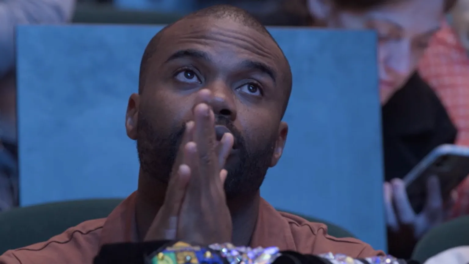 HopSkip Productions Tomi's dad, Boye holding his hands together looking at the stage for final results of the Irish Dancing world championships 2025