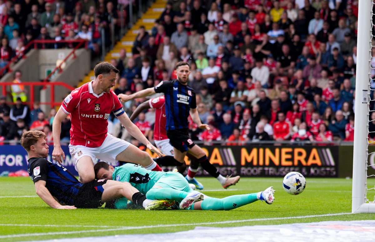 Middlesbrough's Tommy Conway (left) prods the ball home to open the scoring at Wrexham.