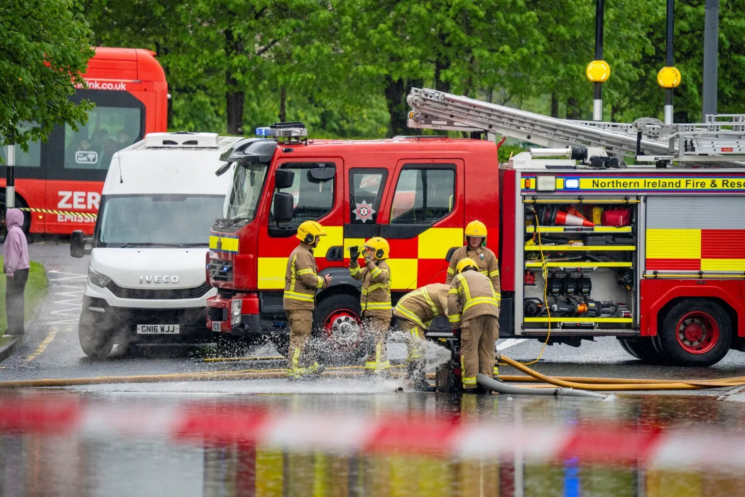 Aodhán Roberts A fire engine with four fire fighters standing in front of it 
