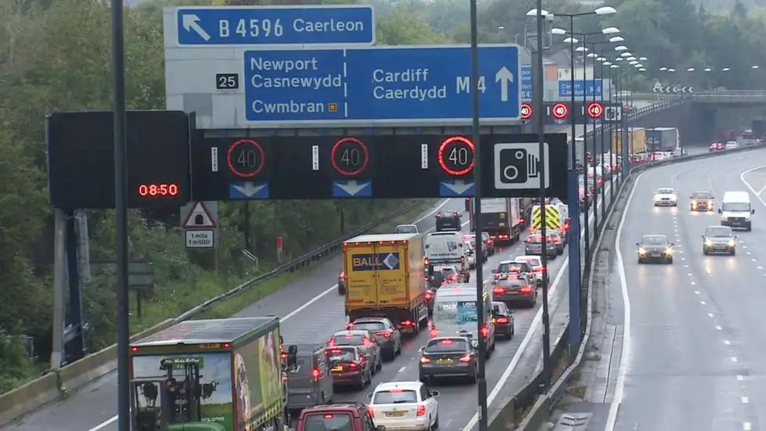 A motorway in Newport with blue signs indicating that drivers should be in the left hand lane for Newport and Cwmbran, and the right two lanes for Cardiff.