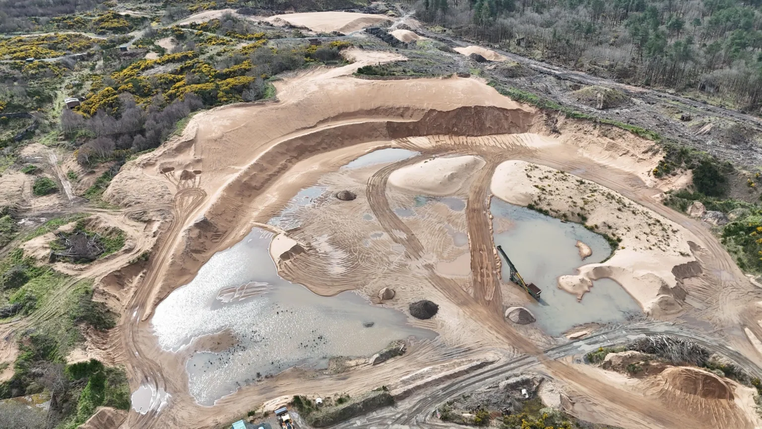 Ardeer Action Group An aerial drone shot of sand dunes and greenery. Work has clearly taken place on the site.