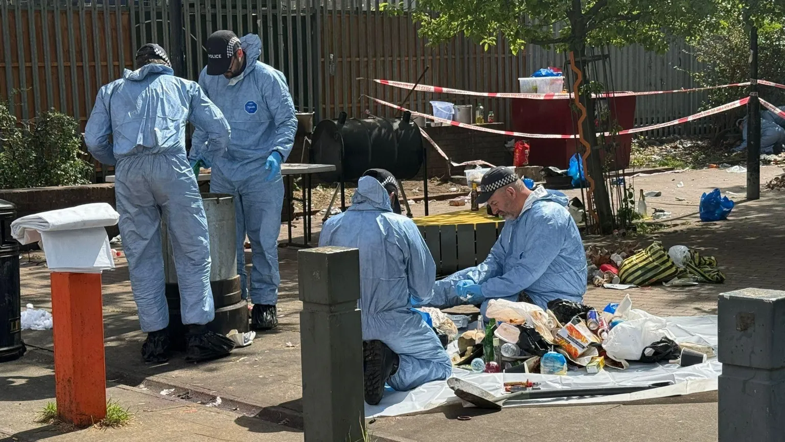 Rory Bibb/BBC Forensics workers at the scene of a shooting in Brixton, south London