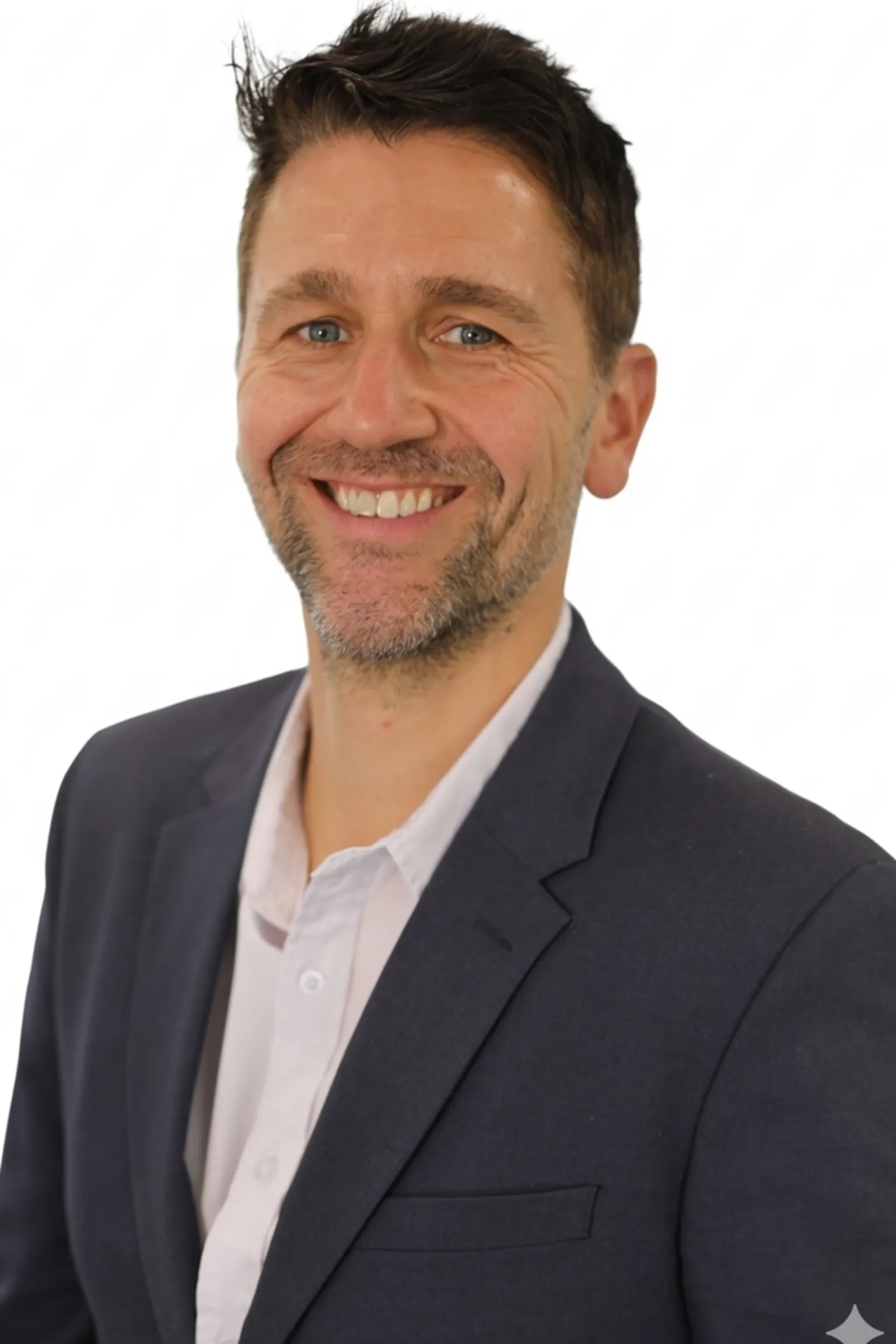 Welsh Conservatives A man in a dark suit with a white shirt smiles looking directly at the camera. He has dark hair, blue eyes and short facial hair