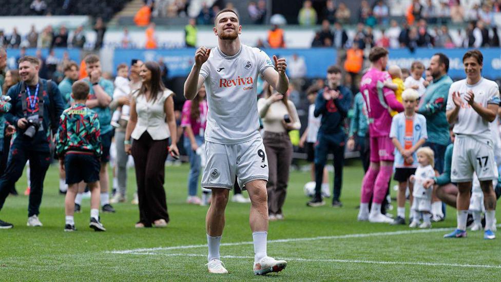 Zan Vipotnik celebrates with Swansea fans after their win over Charlton on the final day of the season 