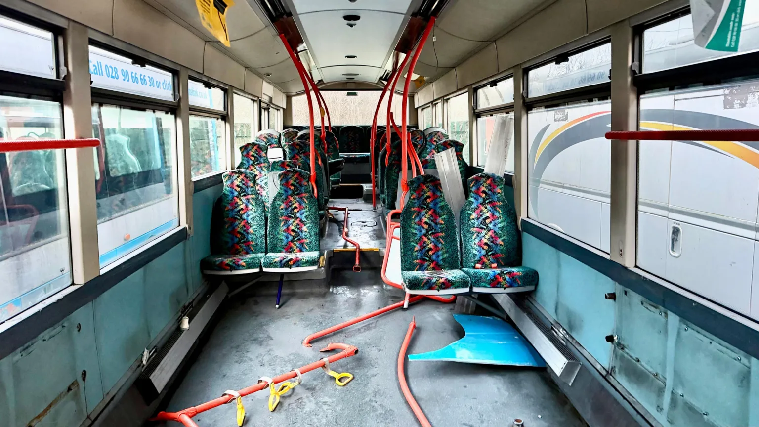 Luke Wilson The inside of a bus with parts ripped out.
