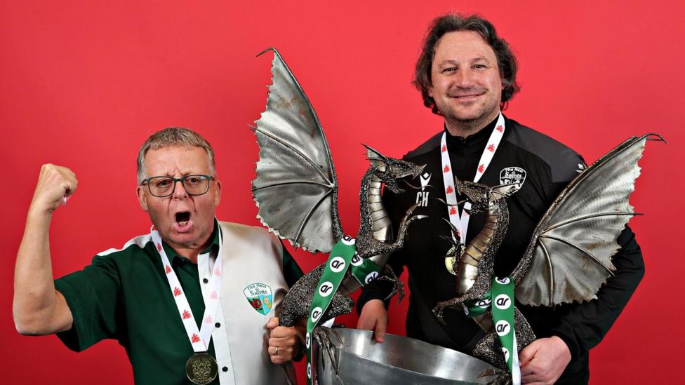 TNS owner Mike Harris (left) and Craig Harrison with the Cymru Premier trophy