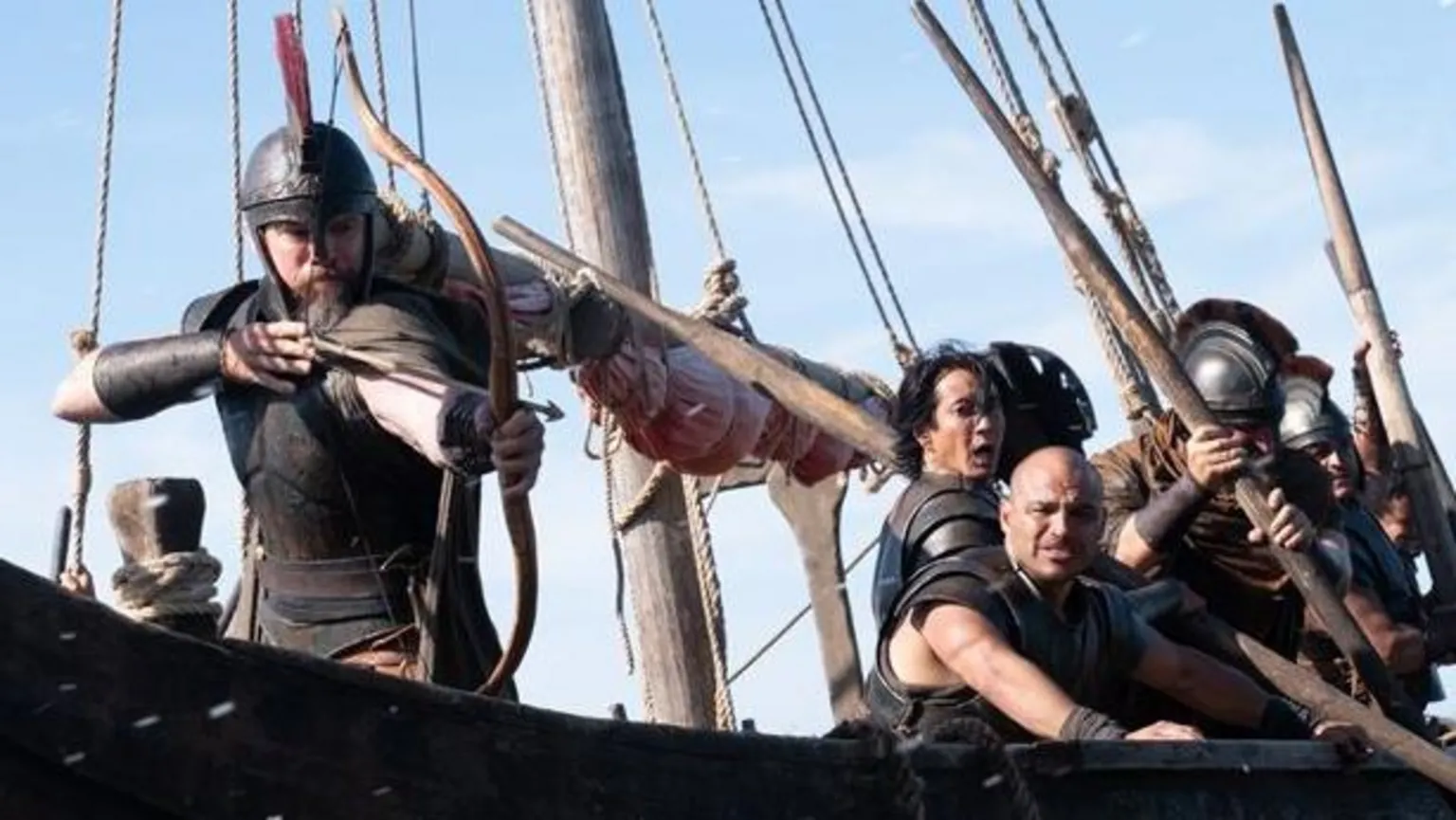 Universal Pictures Matt Damon as Odysseus, firing a bow from a ship