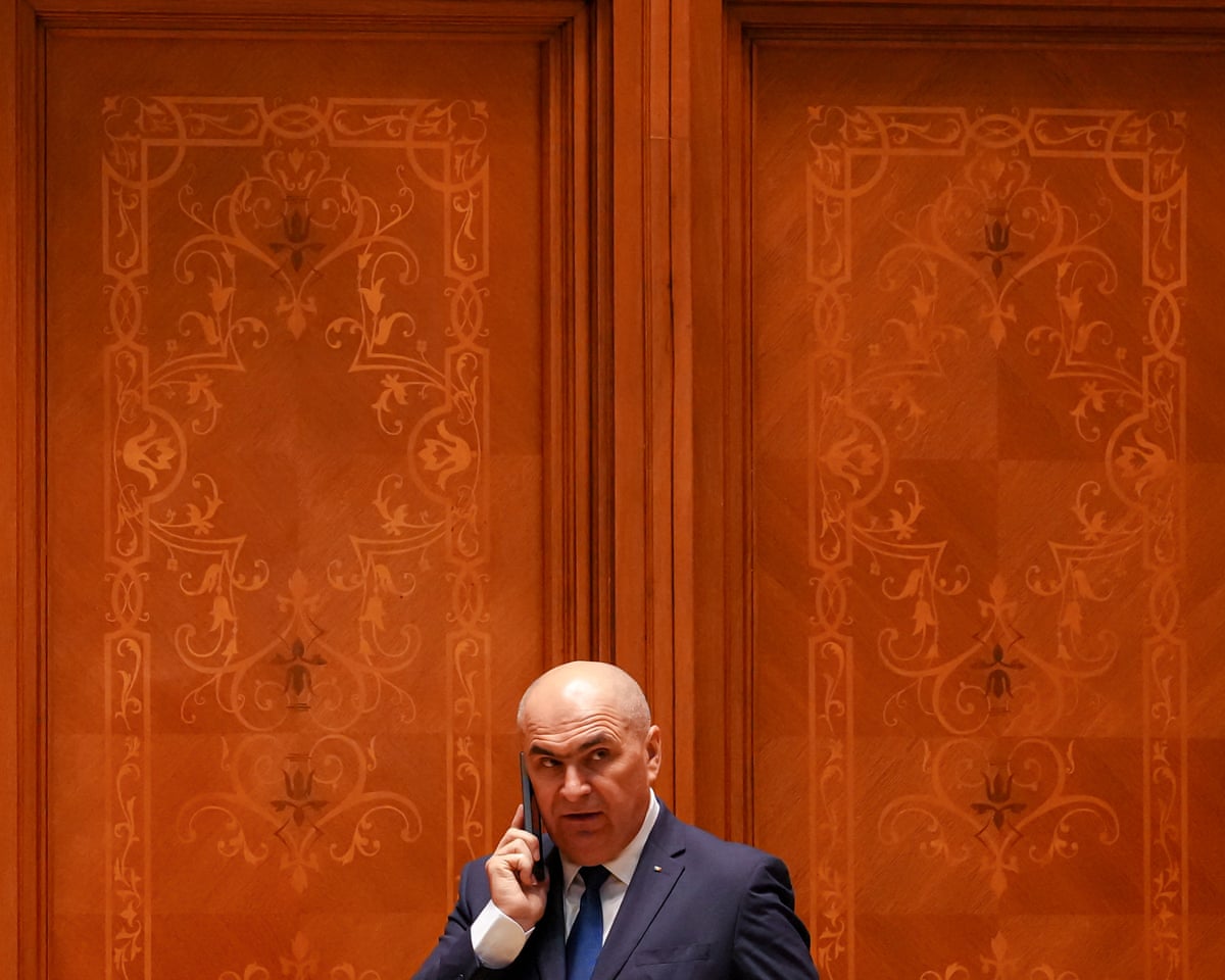 Romanian Prime Minister Ilie Bolojan talks on the phone during a no confidence vote in Bucharest, Romania.
