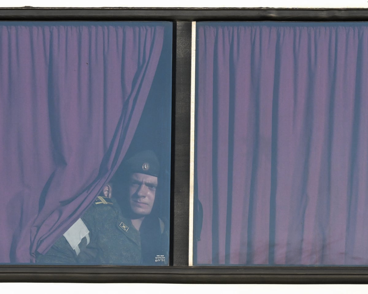 Russian serviceman looks through the window of the bus before the rehearsal of the Victory Day military parade, to be held at Red Square, in central Moscow.