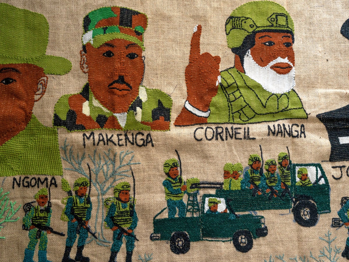 Tapestry of three men in military uniform above depictions of soldiers in army trucks. 