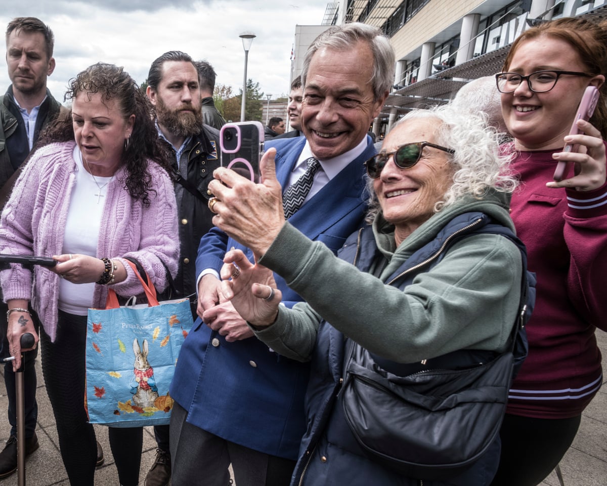 Nigel Farage poses for a selfie with a smiling woman