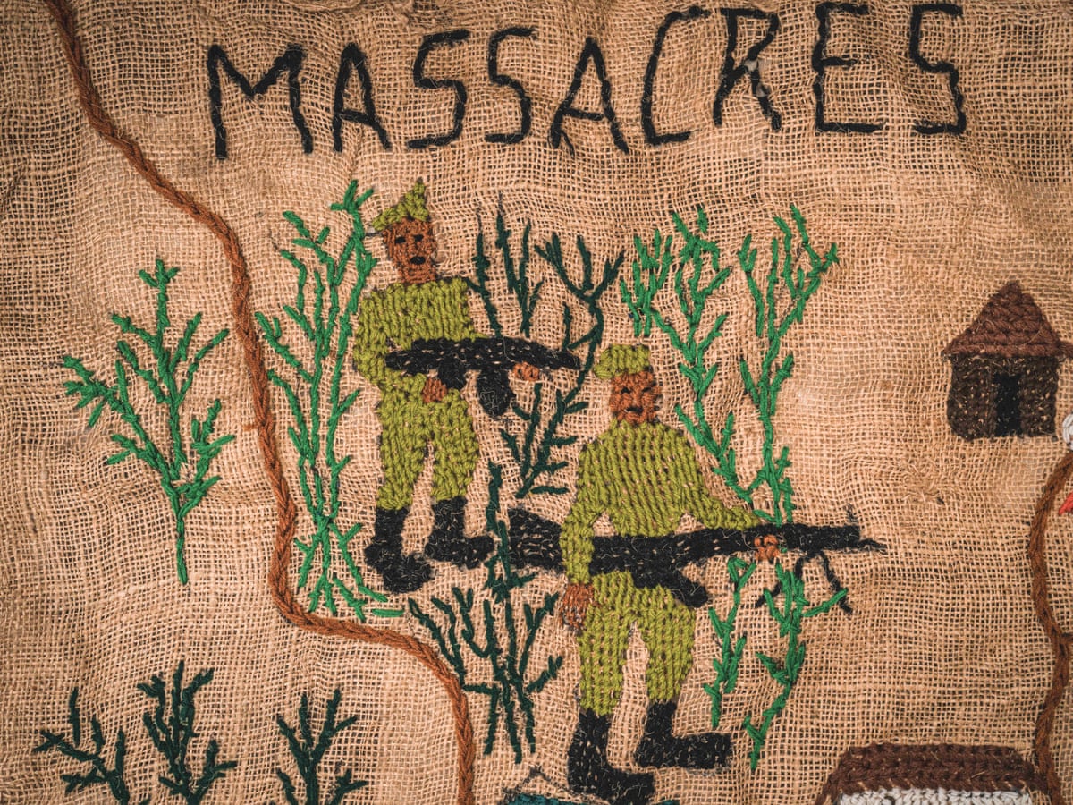 Tapestry of two men with rifles with the word massacres written above them.