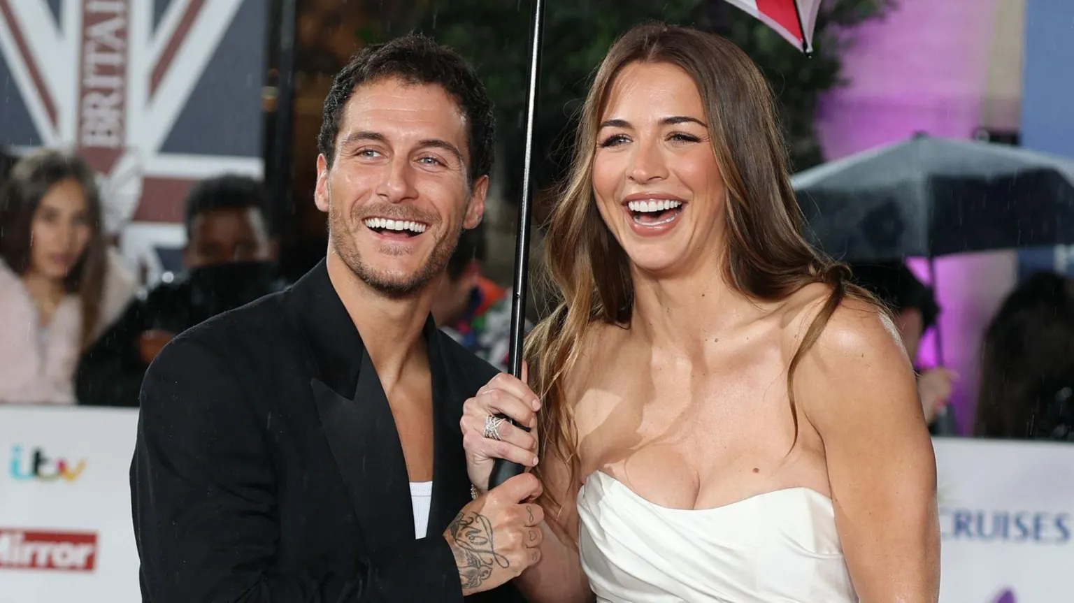  Gorka Márquez and Gemma Atkinson smiling together and holding an umbrella on the red carpet at the Pride Of Britain Awards 2025 