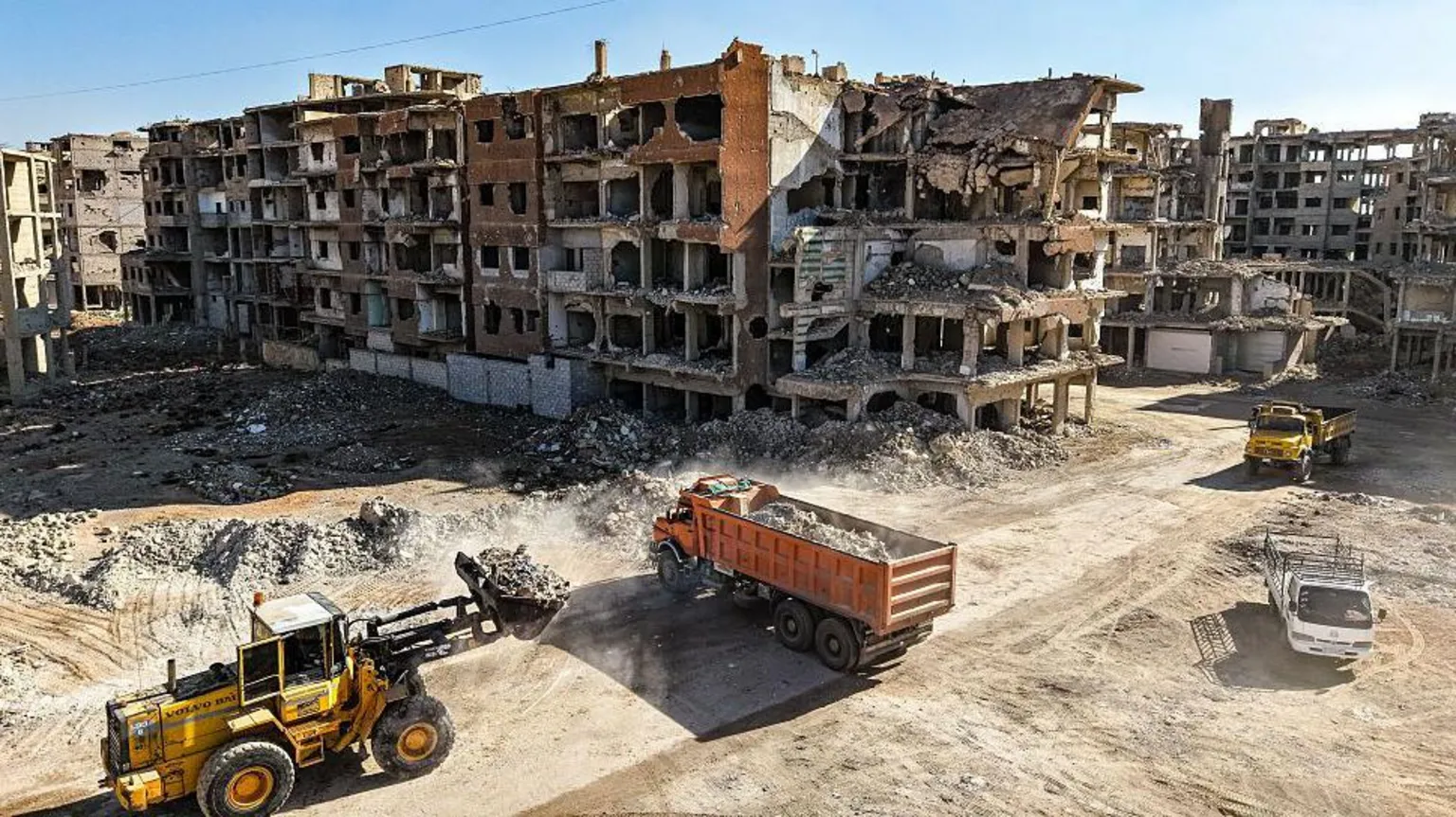 AFP via Trucks removing debris from a street in Syria