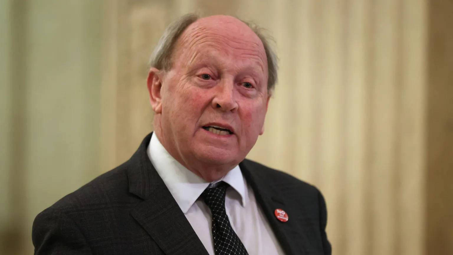  Jim Allister, wearing a white shirt, black tie and black suit. 