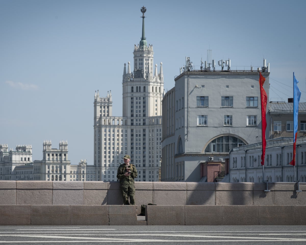 A man in military uniform checks his mobile phone in Moscow, Russia.