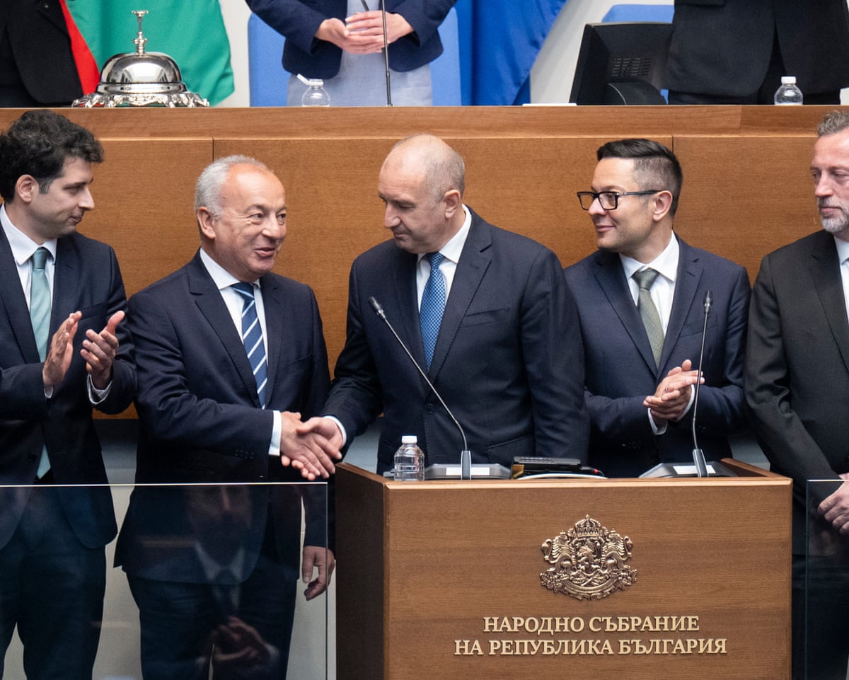 Bulgaria's new prime minister and former president Rumen Radev (C) shakes hands with a member of his newly elected cabinet during the swearing-in of the new government in at the Bulgarian Parliament building in Sofia, Bulgaria.