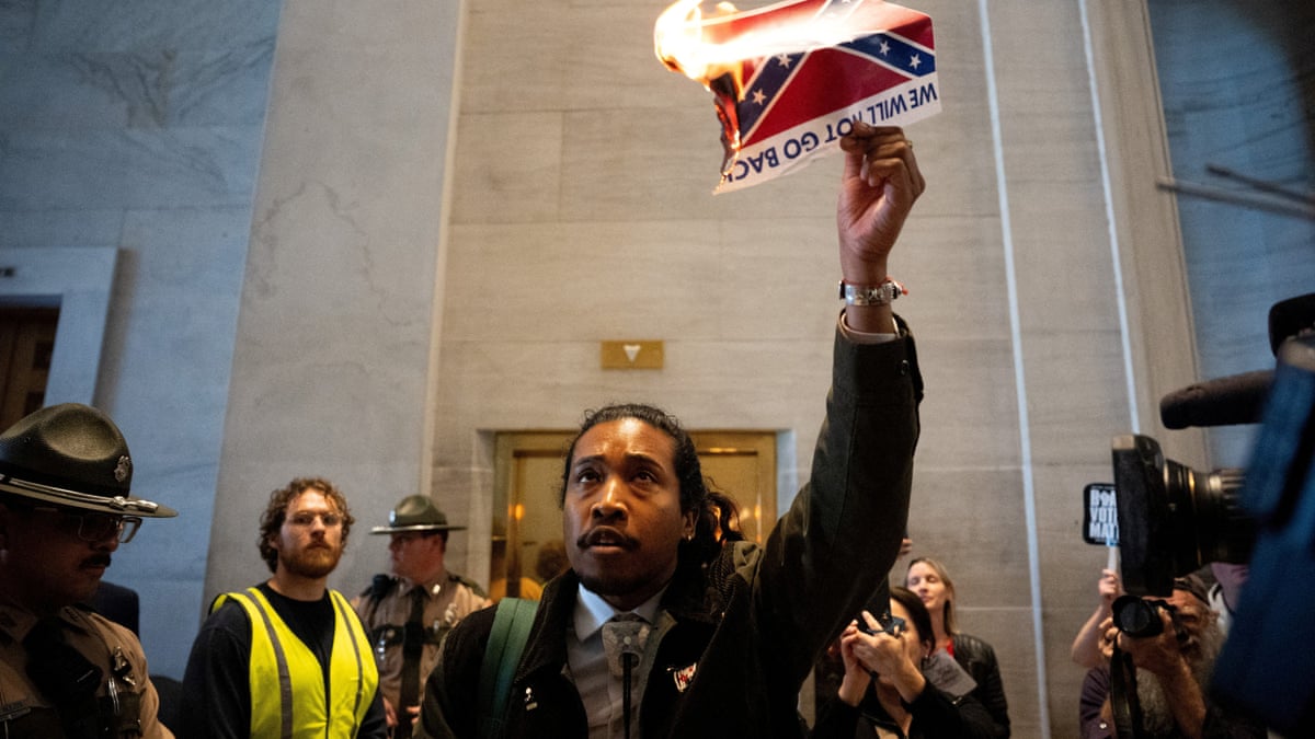 Democratic state representative Justin Jones burning photo of the confederate flag. 